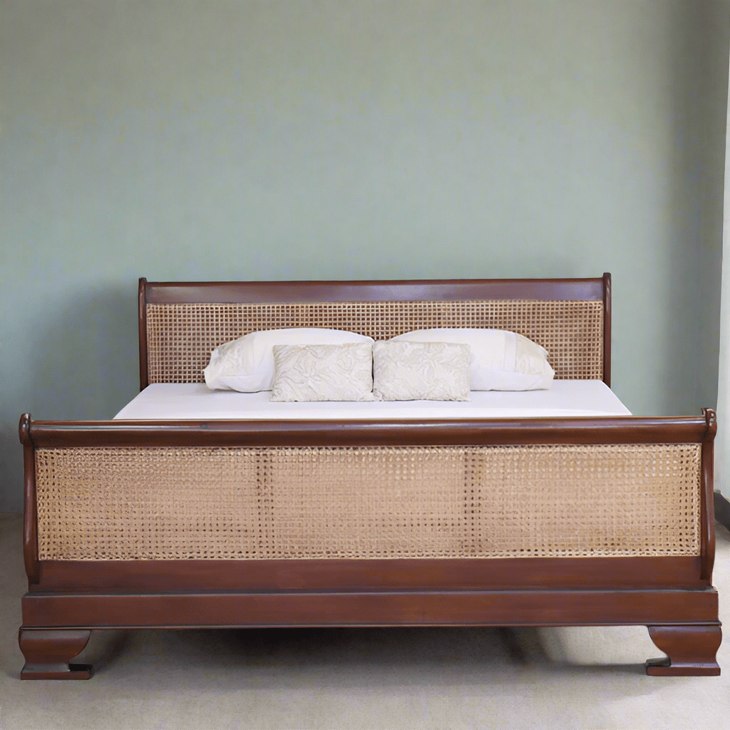 Wooden bed with wicker headboard and footboard against a plain wall.