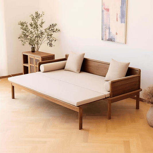 Wooden sofa bed in a room with a plant and abstract painting on the wall.