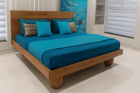 Teak wood bed with unique teak wood ball legs and a bedding