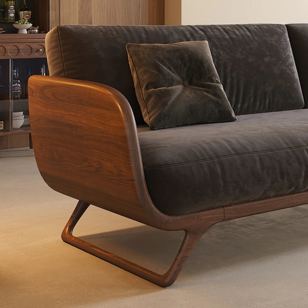 Brown sofa with wooden armrests in a room setting