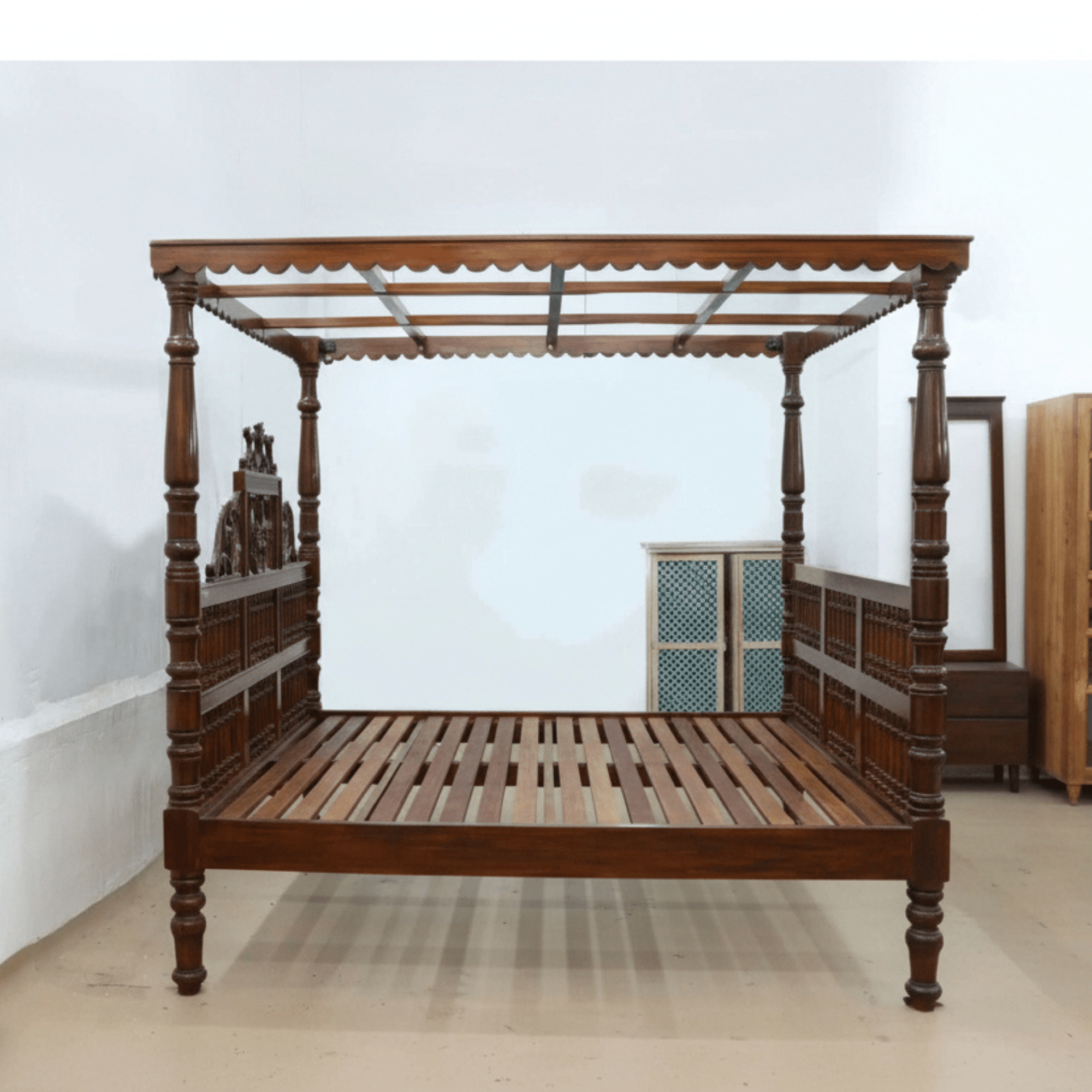 South Indian four poster teakwood bed with carved pillars with wooden slats
