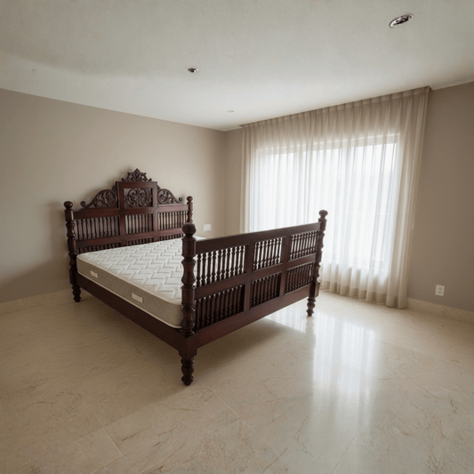 Solid teak wood bed with carved South Indian headboard in a modern bedroom