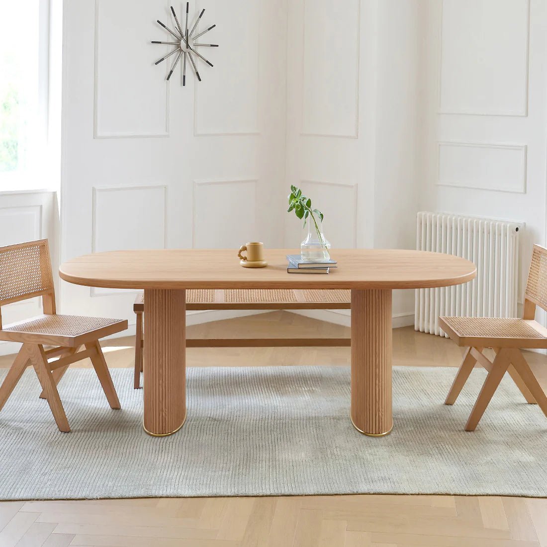 Wooden dining table with chairs in a bright room