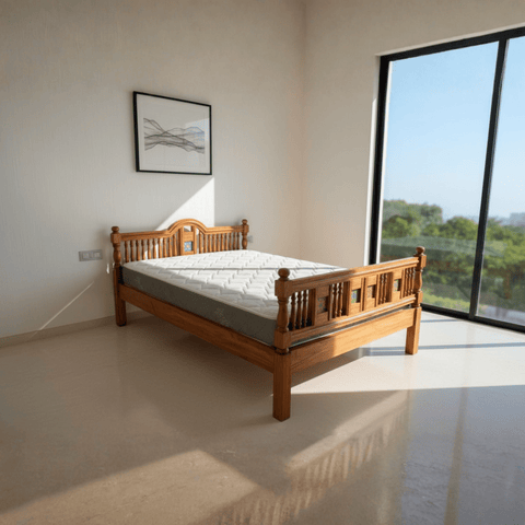 Angled view of solid teak wood bed in a naturally lit bedroom