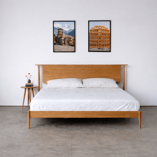 Luxury solid teak wood platform bed with curved headboard in a premium modern bedroom