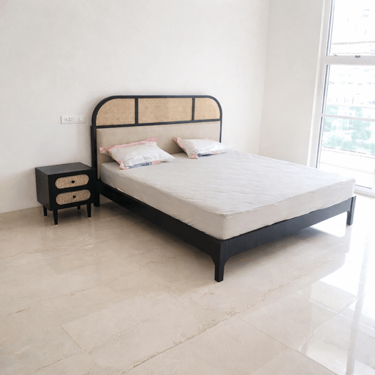 Modern cane upholstered teak wood bed with mattress in black finish, handcrafted headboard design