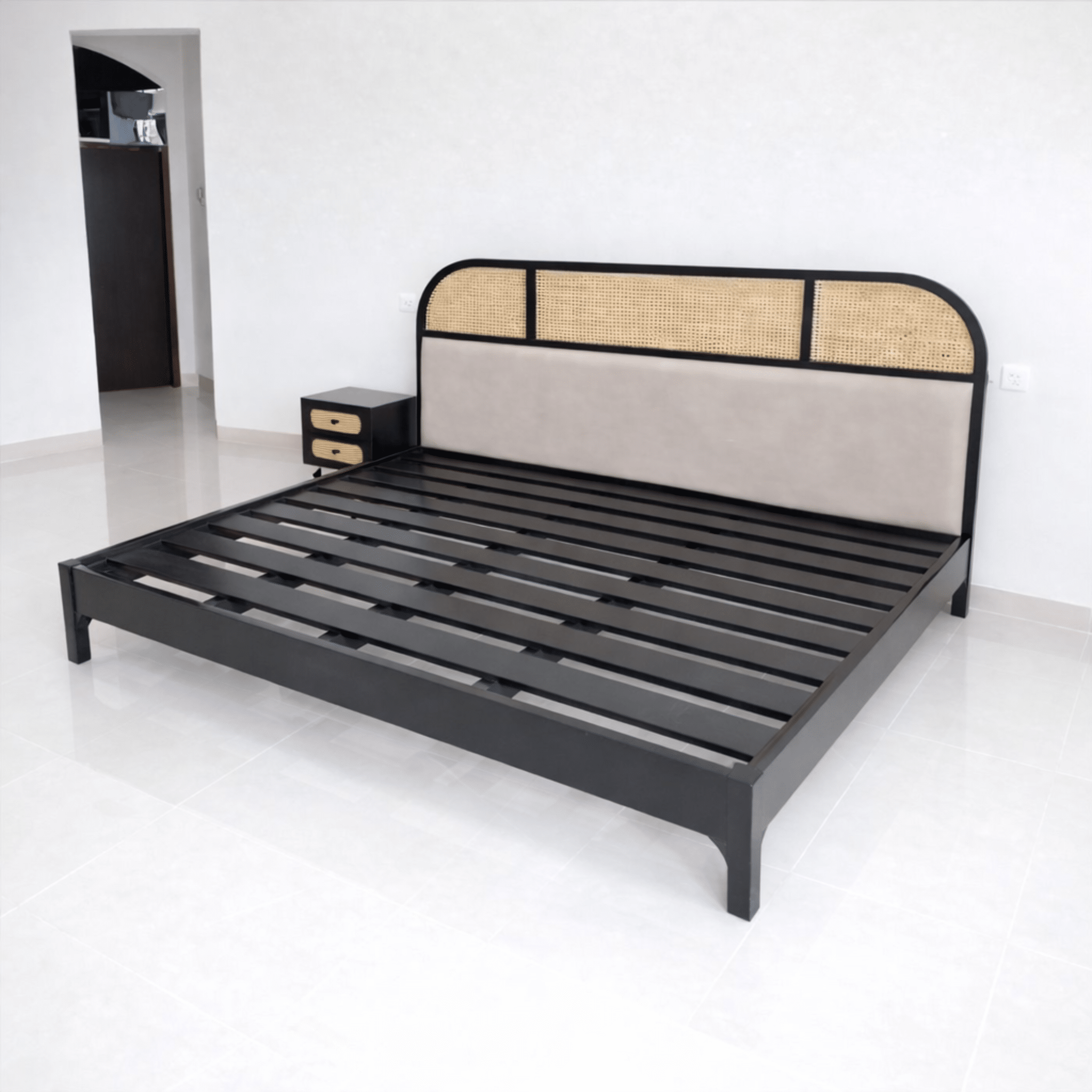 Close-up of handcrafted cane and upholstered headboard on premium teak wood bed
