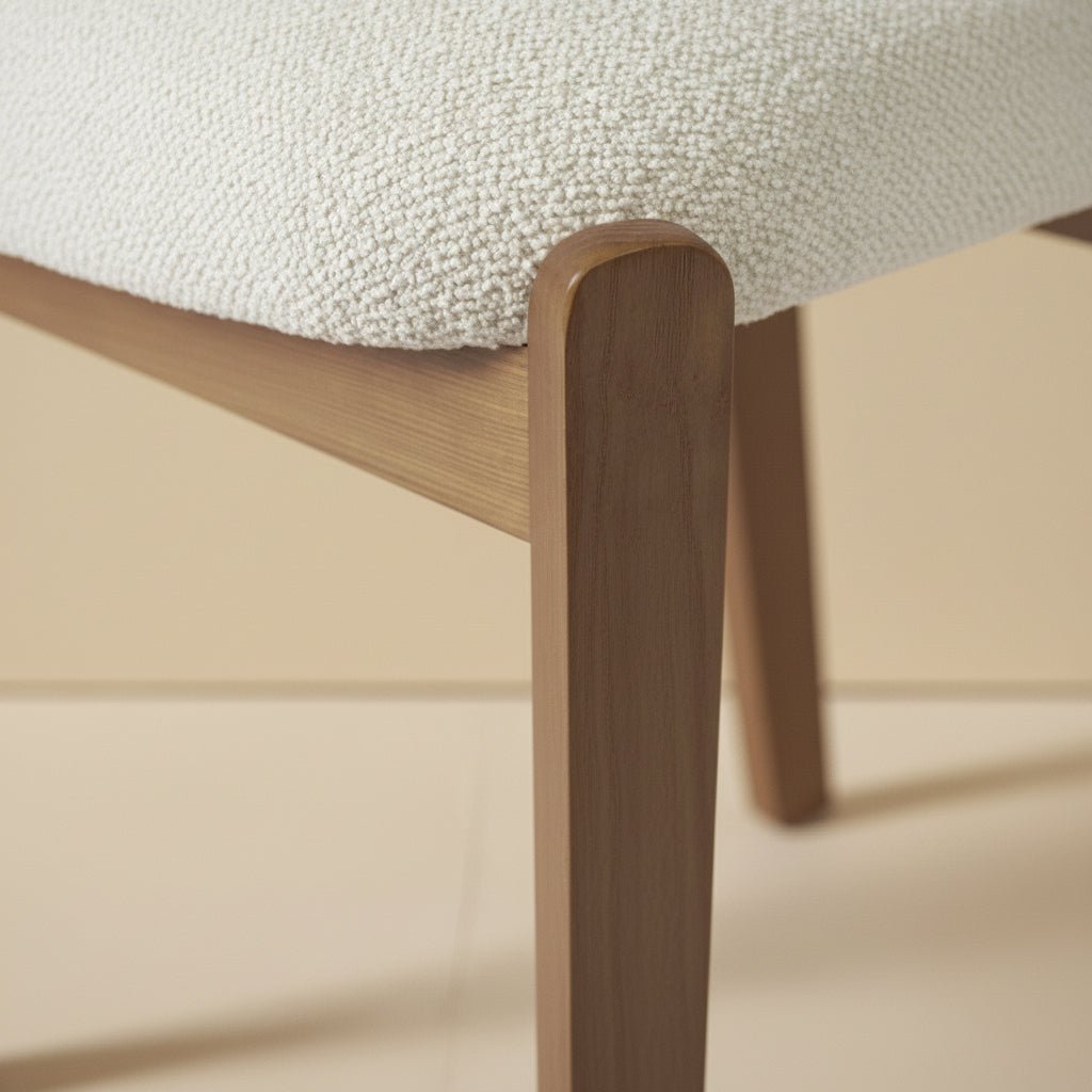 solid teak dining chair with rounded upholstered backrest and cushioned seat