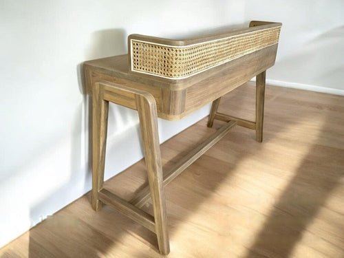 Minimalist wooden desk made of teak with curved legs and cane detailing