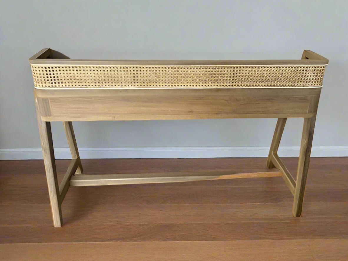 Minimalist wooden desk made of teak with curved legs and cane detailing