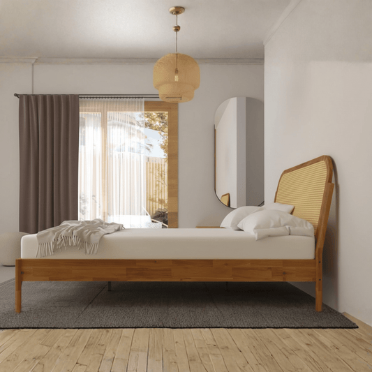 Side view of solid teak wood cane bed with sleigh headboard and natural finish